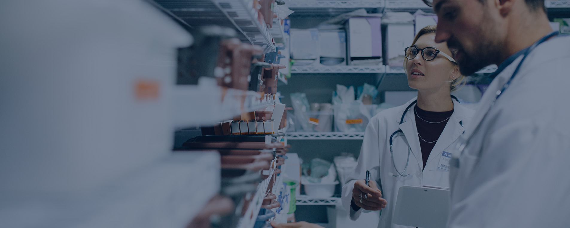 Pharmacist searching drugstore shelf